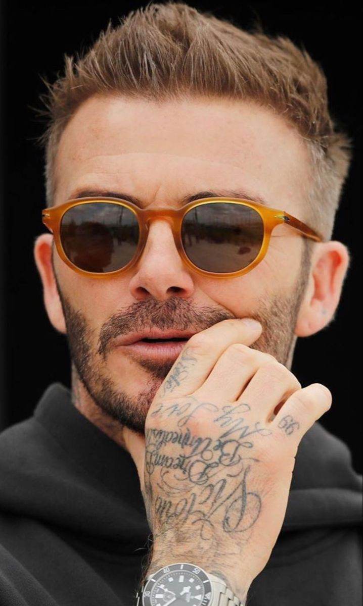  model wearing green oval sunglasses for men amber tortoiseshell frame dark lenses
